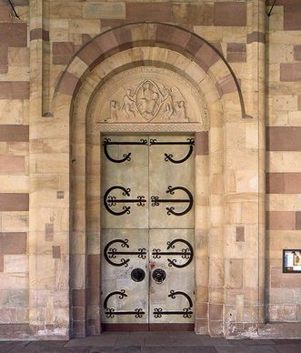 The main door of the monastery church features the original Romanesque metalwork